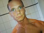 Hot spectacled mature gay Boris likes demonstrating his big body before webcam.